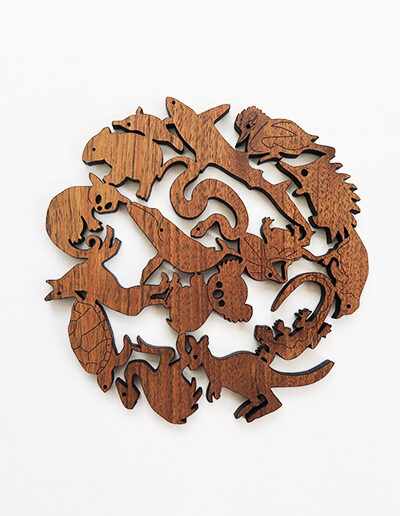 A round wooden Australian animals design trivet