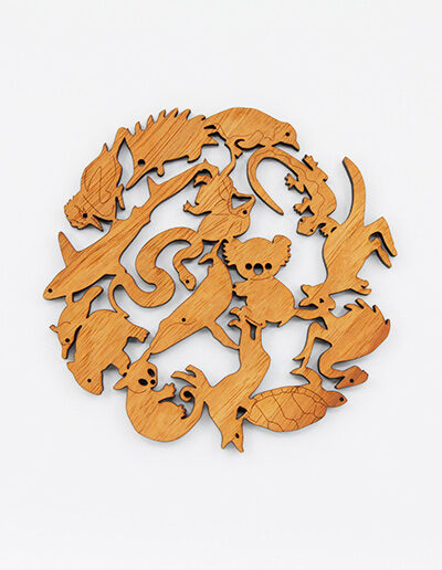 A round wooden Australian animals design trivet