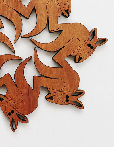 A round wooden kangaroo design trivet