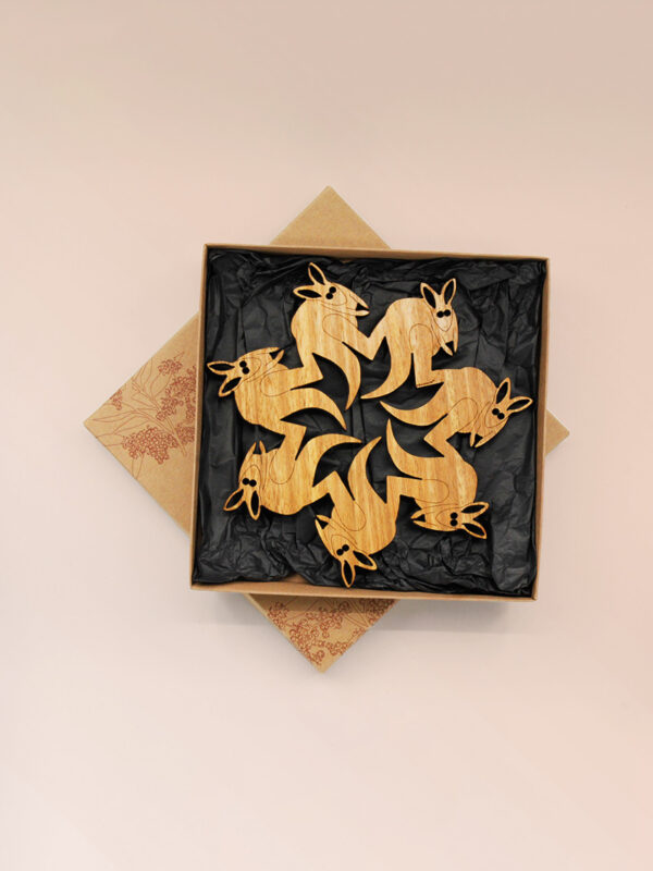 A round wooden kangaroo design trivet in a recycled card presentation box
