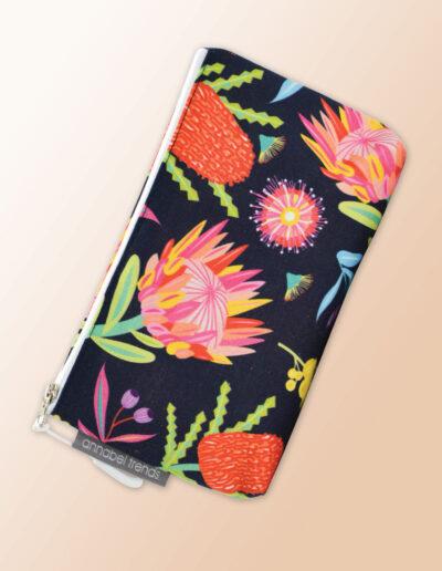 Small water resistant cosmetic bag with an Aussie Flora pattern on it and a zip closure.