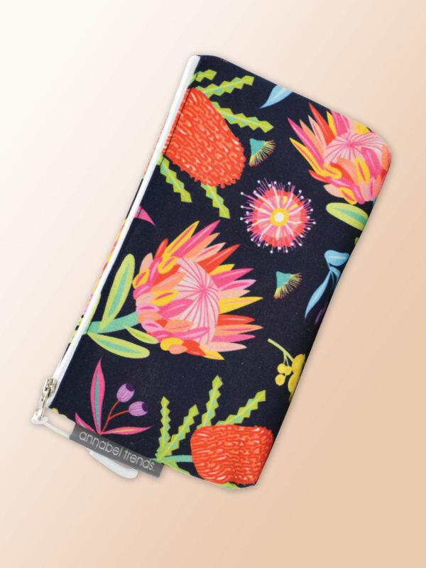 Small water resistant cosmetic bag with an Aussie Flora pattern on it and a zip closure.
