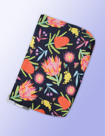 Large water resistant cosmetic bag with an Aussie Flora pattern on it and a zip closure.