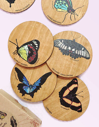 Set of six wooden coasters and their recycled cardboard presentation box. Each coaster is a different coloured butterfly.