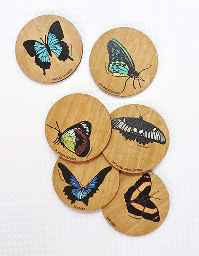 Set of six wooden coasters. Each coaster is a different coloured butterfly.