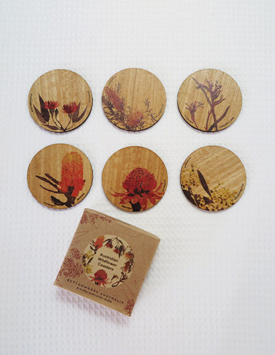 Set of six wooden coasters and their recycled cardboard presentation box. Each coaster is a different coloured native flower of Australia.