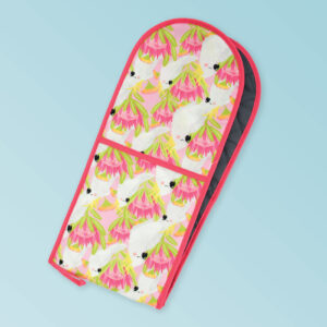Insulated double oven mitts with a pink cockatoo pattern on the fabric and a dark pink edging..