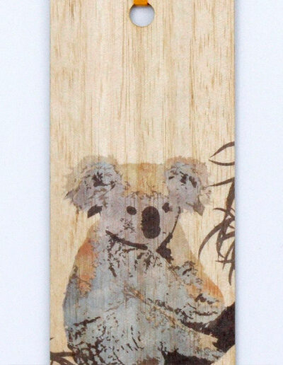 A close up of an Australian made wooden coloured Koala bookmark presented on recycled card