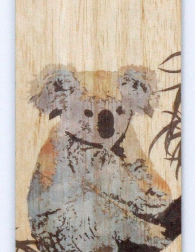 A close up of an Australian made wooden coloured Koala bookmark presented on recycled card