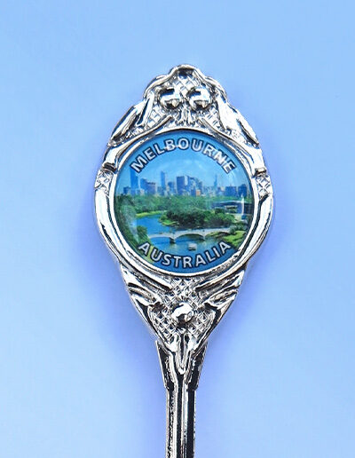 The crest of a souvenir spoon with the Melbourne skyline on it.