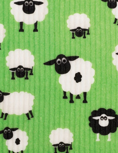 A close up of a dishcloth with a fun sheep design on it