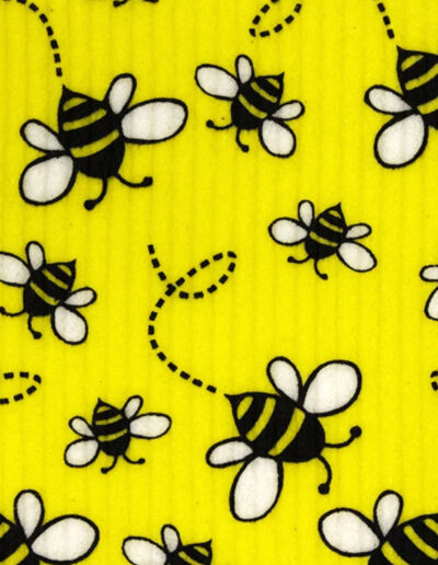A close up of a dishcloth with a cute bee design on it