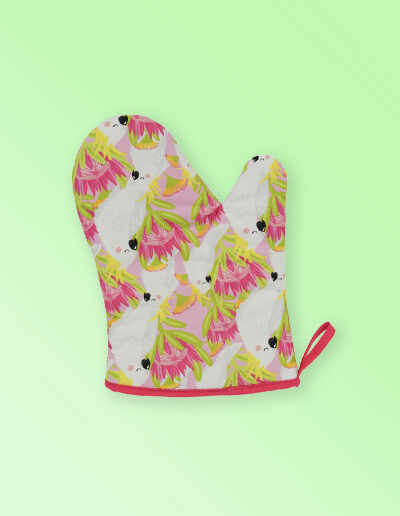 Insulated single oven mitt with a pink cockatoo pattern on the fabric and a dark pink edging..