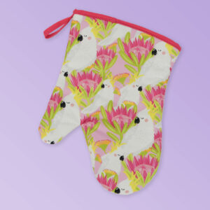 Insulated single oven mitt with a pink cockatoo pattern on the fabric and a dark pink edging..