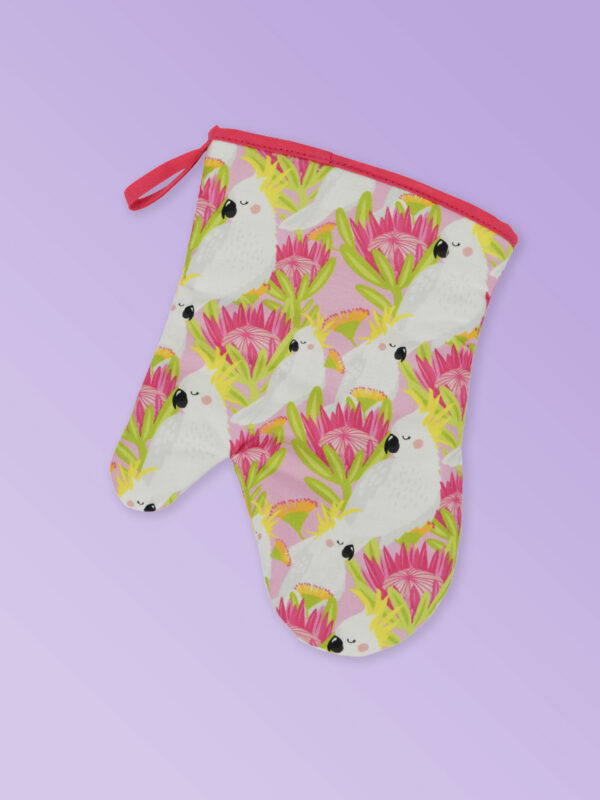 Insulated single oven mitt with a pink cockatoo pattern on the fabric and a dark pink edging..