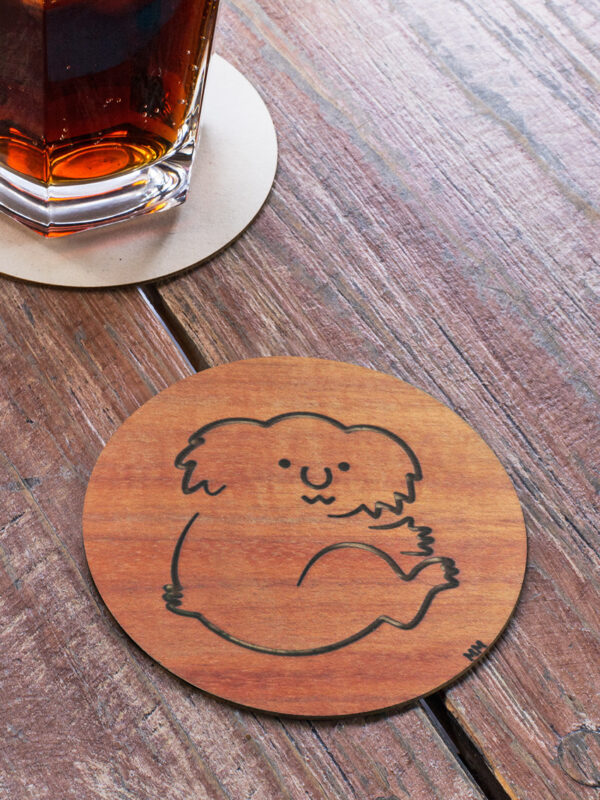 Wooden Koala round coaster on a table