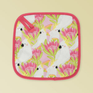 Insulated pot holder with a pink cockatoo pattern on the fabric and a dark pink edging with a hang tab.