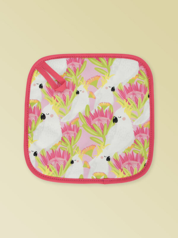 Insulated pot holder with a pink cockatoo pattern on the fabric and a dark pink edging with a hang tab.