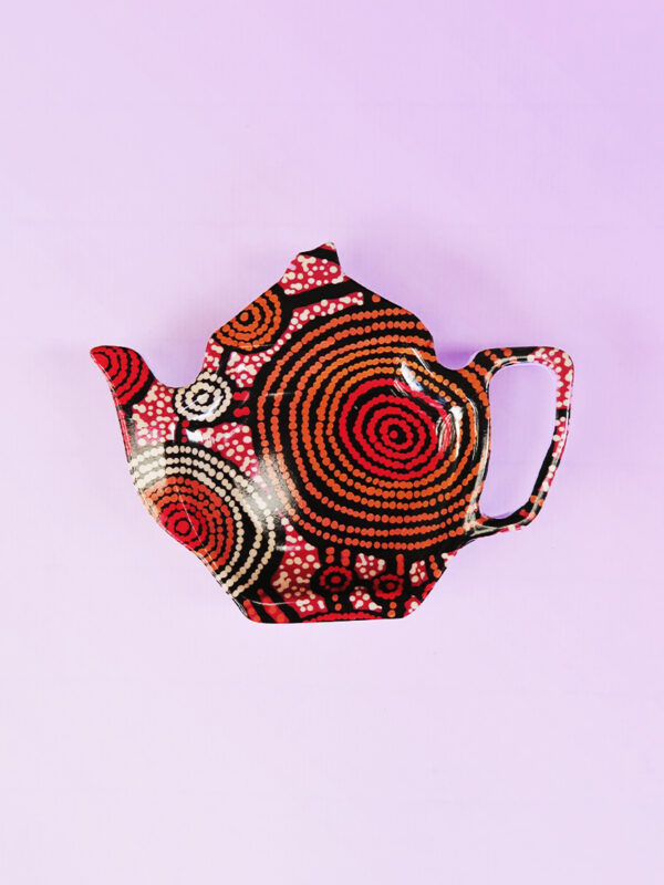 Melamine tea bag holder in the shape of a teapot. The pattern on it is artwork by Teddy Gibson.