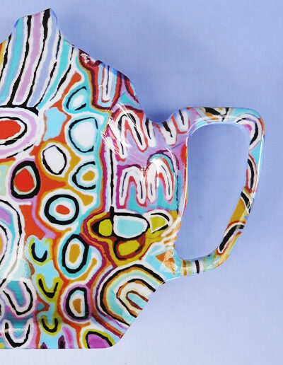 A close up melamine tea bag holder in the shape of a teapot
