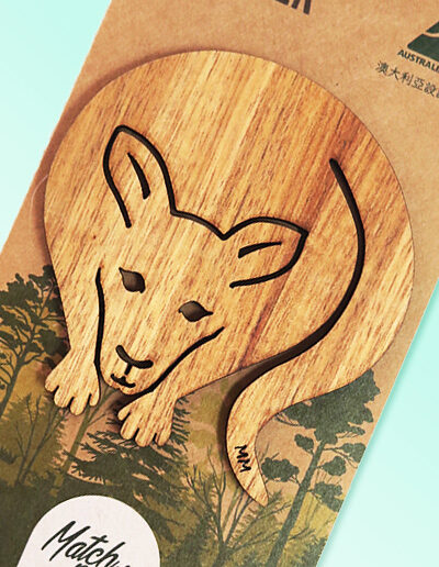A wooden kangaroo shape coaster on a recycled card for presentation