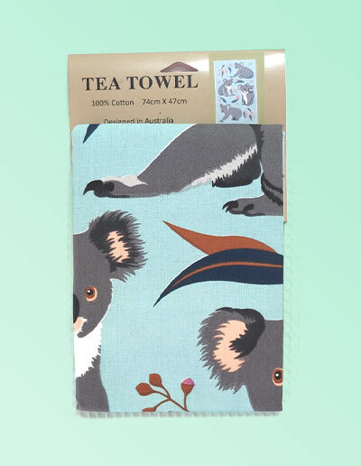 A light blue cotton tea towel with Koala images printed on it.