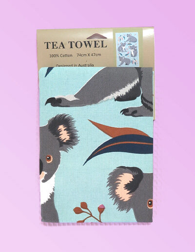 A light blue cotton tea towel with Koala images printed on it.