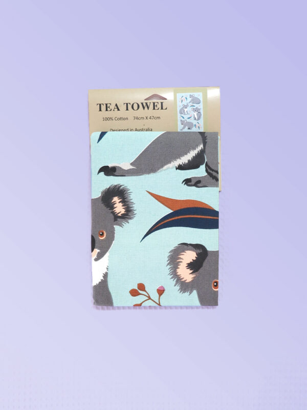 A light blue cotton tea towel with Koala images printed on it.