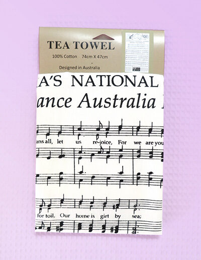 A white cotton tea towel with Australia's National Anthem in words and music on it.