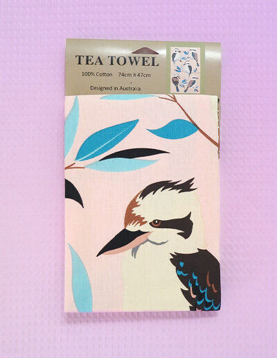 A light pink cotton tea towel with Kookaburra images printed on it.