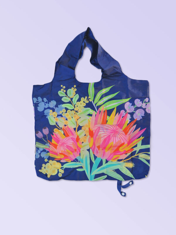 Foldable strong shopping bag printed with illustrations of Australian flora. It has a navy background. Made with polyester.