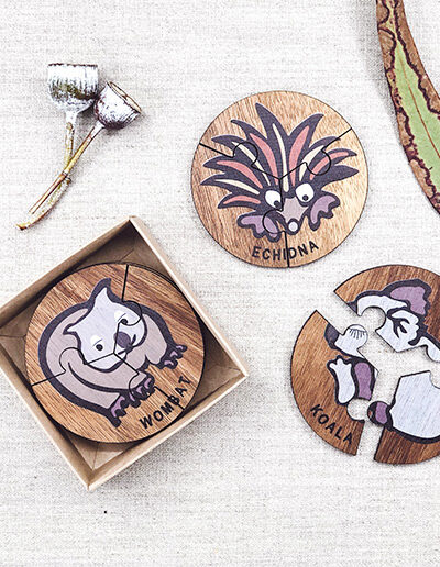 Wooden Australian Animal jigsaw puzzle set. A set of 6 different three piece animal jigsaws. Each is a round shape. They are packaged in a recycled cardboard presentation box