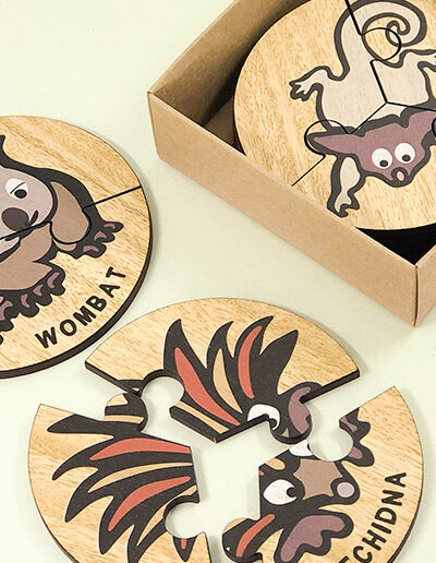 Wooden Australian Animal jigsaw puzzle set. A set of 6 different three piece animal jigsaws. Each is a round shape. They are packaged in a recycled cardboard presentation box