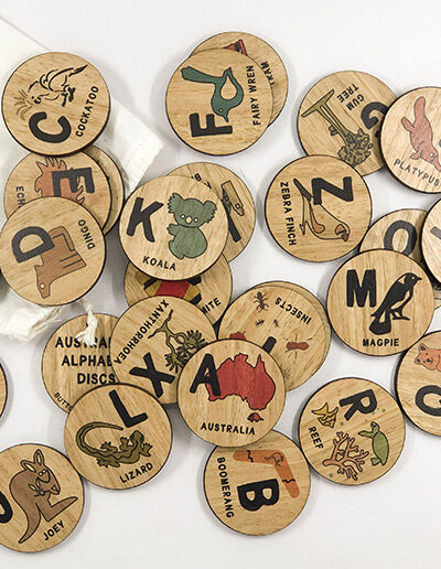 Wooden Australian Alphabet discs. 26 round wooden discs every letter of the alphabet and an image to go with that letter. e.g N is Ned Kelly.