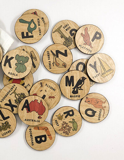 Wooden Australian Alphabet discs. 26 round wooden discs every letter of the alphabet and an image to go with that letter. e.g N is Ned Kelly.