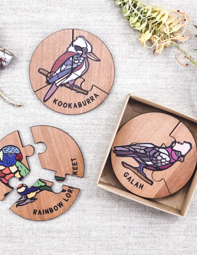 Wooden bird jigsaw puzzle set. A set of 6 different three piece bird jigsaws. Each is a round shape. They are packaged in a recycled cardboard presentation box