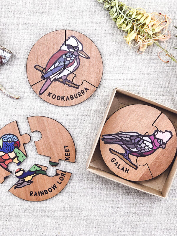 Wooden bird jigsaw puzzle set. A set of 6 different three piece bird jigsaws. Each is a round shape. They are packaged in a recycled cardboard presentation box
