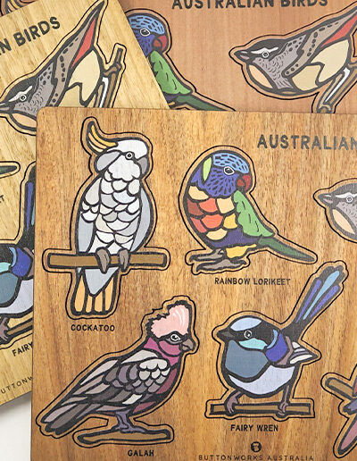 A wooden bird puzzle. Rectangular in shape with 6 different colourful bird shapes to place back in the correct cut out shape.