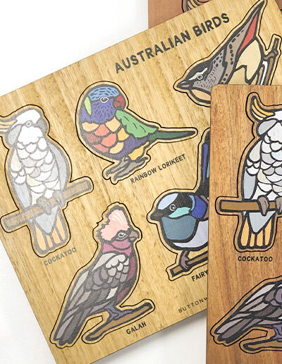 A wooden bird puzzle. Rectangular in shape with 6 different colourful bird shapes to place back in the correct cut out shape.