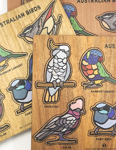 A wooden bird puzzle. Rectangular in shape with 6 different colourful bird shapes to place back in the correct cut out shape.