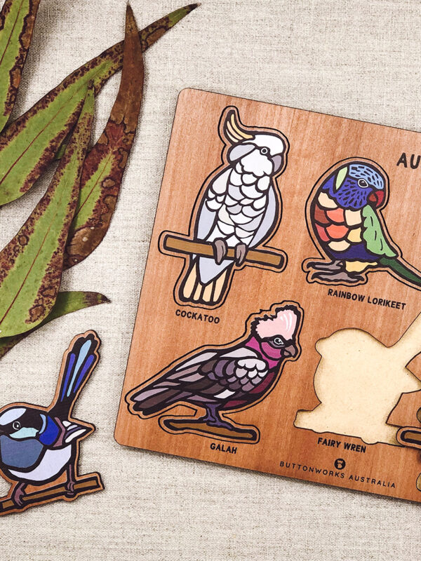 A wooden bird puzzle. Rectangular in shape with 6 different colourful bird shapes to place back in the correct cut out shape.