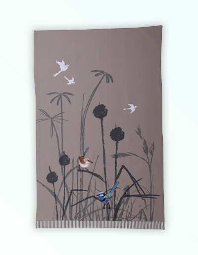 Tea towel with an embroidered pair of blue wrens perched in grasses. The fabric is a natural Australian organic cotton.