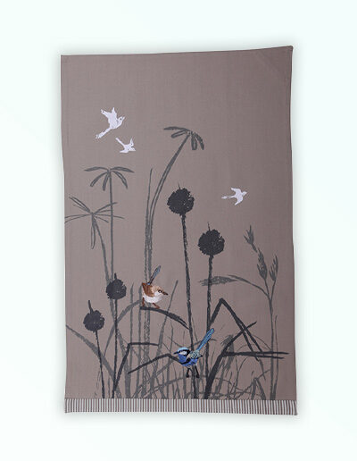Tea towel with an embroidered pair of blue wrens perched in grasses. The fabric is a natural Australian organic cotton.