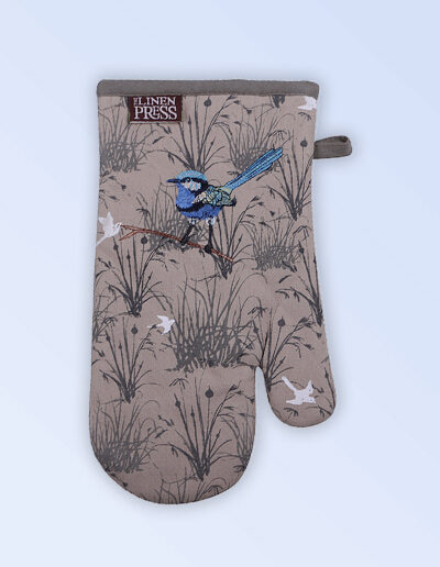 Insulated single oven mitt with an embroidered blue wren perched in grasses as the fabric design. The fabric is a natural Australian organic cotton with brown/grey trim around it and a tab to hang it.
