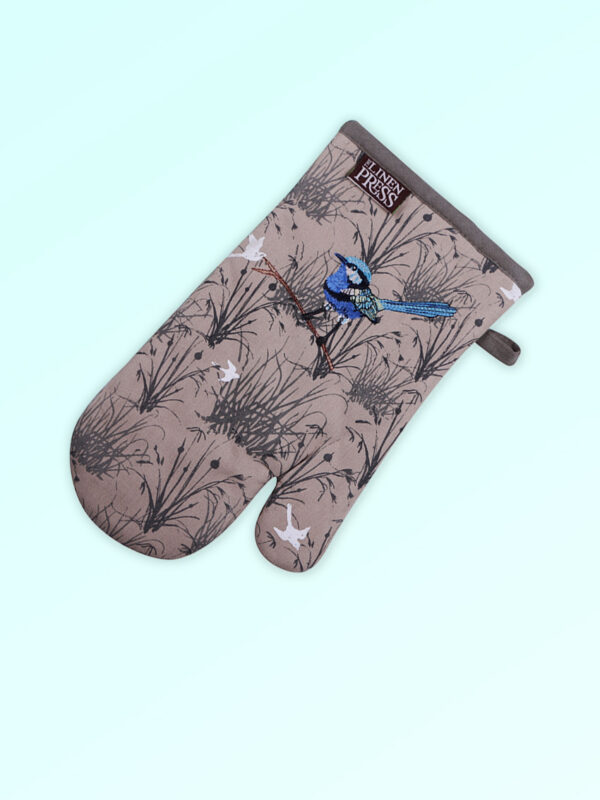 Insulated single oven mitt with an embroidered blue wren perched in grasses as the fabric design. The fabric is a natural Australian organic cotton with brown/grey trim around it and a tab to hang it.