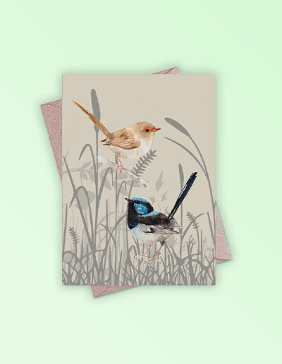 Greeting card printed in Australia. Made with recycled card. It has an image of a pair of blue wren birds in grassland on the front and is blank inside.