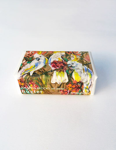 Bar of soap wrapped in paper with a Cockatoo design.