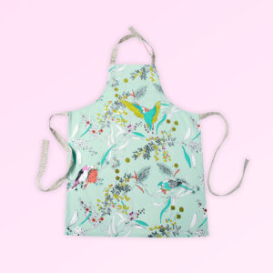 Kitchen apron with adjustable neck strap. The fabric is Australian organic cotton with an aqua background and budgerigars and small native flowers in pastel colours. The neck strap and waist straps are a soft grey.