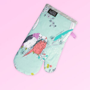 Single insulated oven mitt. The fabric is Australian organic cotton with an aqua background and budgerigars and small native flowers in pastel colours. The trim around it is soft grey with a tab for hanging.