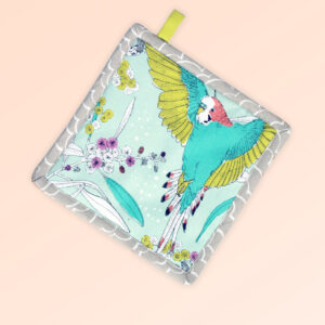 Square insulated pot holder. The fabric is Australian organic cotton with an aqua background and budgerigars and small native flowers in pastel colours. The trim around it is soft grey with a tab for hanging.